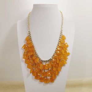 Orange gold tone beaded / bid statement necklace .